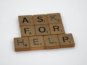 Scrabble tiles arranged to say 'ASK FOR HELP'